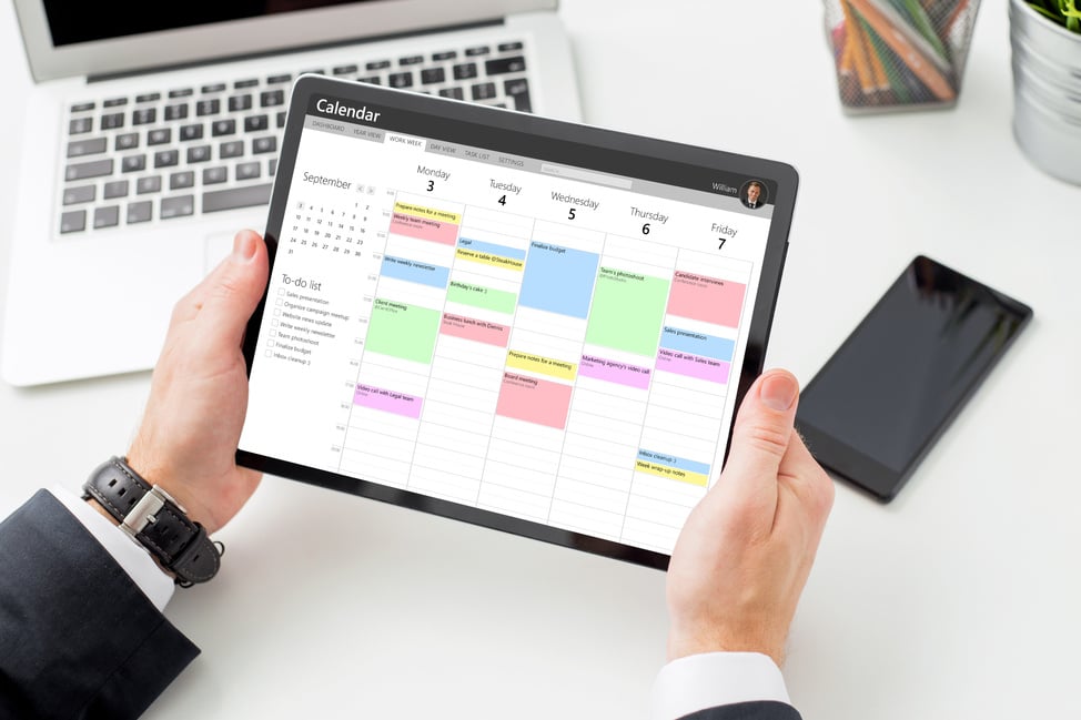 Businessman Using Calendar App on Tablet Computer